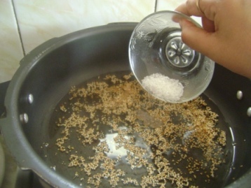 Once porridge changes its color to light brown add water and sugar.